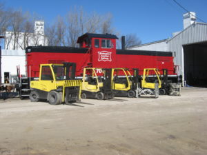 Forklifts in front of locomotive